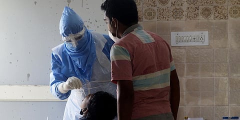 A health worker collecting swab sample near Ganganagar in Bhubaneswar on Thursday. (Photo| EPS)
