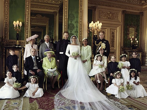 In this photo released by Kensington Palace on Monday May 21, 2018, shows an official wedding photo of Britain's Prince Harry and Meghan Markle, center, in Windsor Castle, Windsor, England, Saturday May 19, 2018. (Photo | AP)