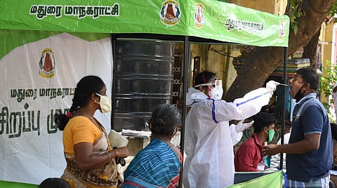 Health workers taking swab sample of a person at a kiosk in Madurai. (Photo | KK Sundar)