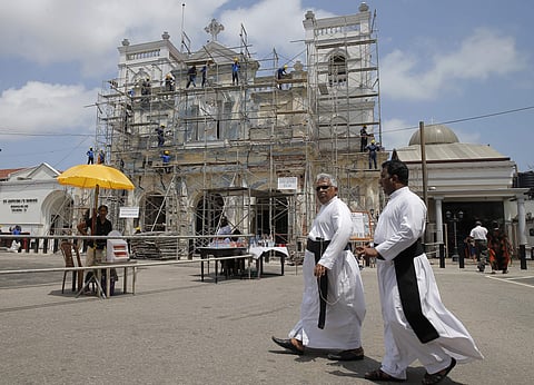 Sri Lankan Catholic priests walk outside the St. Anthony's church after it was partially opened for the first time since Easter Sunday attacks, in Colombo. (File Photo | AP)