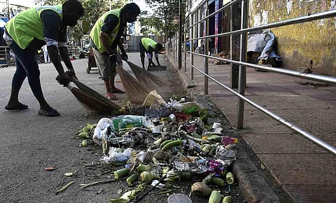 BBMP workers cleaning the Avenue Road  in Bengaluru. (Photo | Vinod Kumar T, EPS)