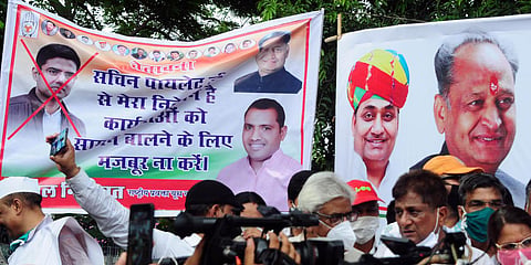 Cross mark is seen on the picture of Sachin Pilot in a poster during a protest by Congress party against BJP in Jaipur. (File photo| ANI)