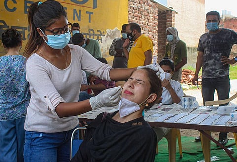 A health worker collects a sample for COVID-19 Real-Time Polymerase Chain Reaction (RT-PCR) test, in Gurugram, Saturday, July 25, 2020. (Photo | PTI)