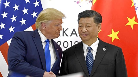 File | U.S. President Donald Trump, left, shakes hands with Chinese President Xi Jinping during a meeting. 