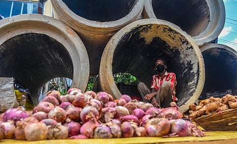 A vegetable vendor takes shelter in a concrete pipe near Jharpada during lockdown in Bhubaneswar. (Photo | Biswanath Swain, EPS)
