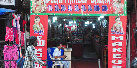 A footwear shop owner in one town area waiting for customers in Visakhapatnam. (Photo| EPS)