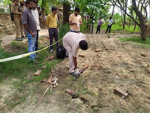 Kanpur Police and forensic team members investigate the encounter site where 8 police personnel lost their lives after being fired upon by criminals in Kanpur Friday July 3 2020. (Photo | PTI)