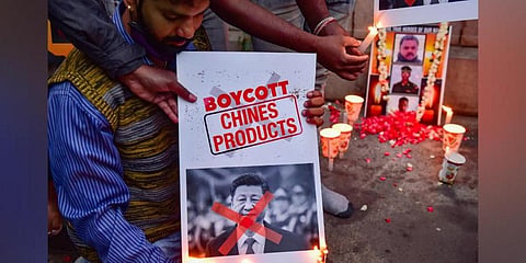 Citizens burn posters of Chinese President Xi Jinping after twenty Indian army personnel were martyred during a clash with Chinese troops in Ladakh's Galwan valley, during the ongoing COVID-19 nationwide lockdown, in Bengaluru. (File Photo | PTI)