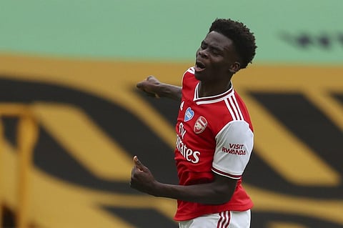 Arsenal's English striker Bukayo Saka celebrates scoring the opening goal. (Photo | AFP)