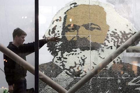 'Nothing can have value without being an object of utility.' IN PIC:  An artist completes an installation featuring a giant portrait of German philosopher and historian Karl Marx, in a Berlin gallery 03 February 2005. (Photo | AFP)