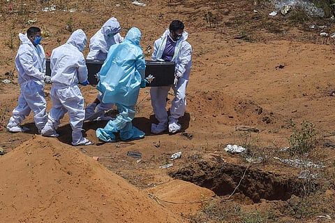 Health workers and relatives carry the body of a COVID19 victim for burial. (Image for representation | PTI)