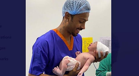 Pandya is seen holding the baby boy in his arms in a hospital. (Photo | Hardik Pandya, Twitter)