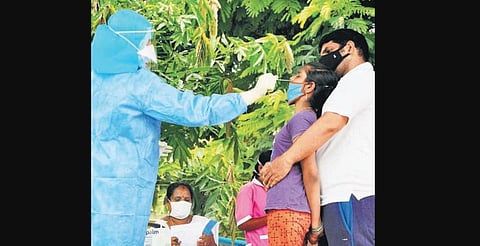 Health workers conducting Covid-19 test on a girl at Chinna Waltair  in Visakhapatnam on Sunday (Photo | G Satyanarayana, EPS)