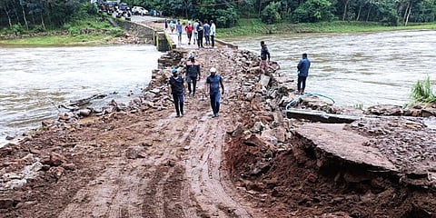 Volunteers engaged in repair works of the bridge (Photo | EPS)