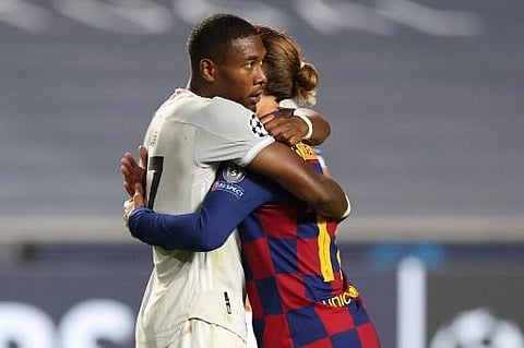 Barcelona's French forward Antoine Griezmann (R) congratulates Bayern Munich's Austrian defender David Alaba at the end of the UEFA Champions League quarter-final | Rafael Marchante/POOL/AFP