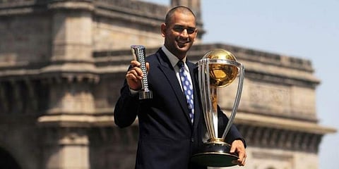 MS Dhoni poses with the Man of the Match and the ICC Cricket World Cup trophy. (Photo | AFP)