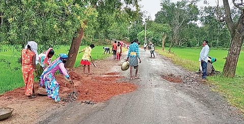 Villagers repairing the stretch of road between Kaptipada and Sarat I Express