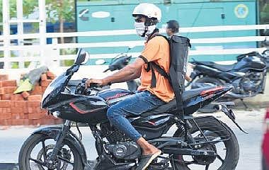 A Swiggy delivery boy wears a mask on his way  to deliver food. (Photo | B P Deepu, EPS)