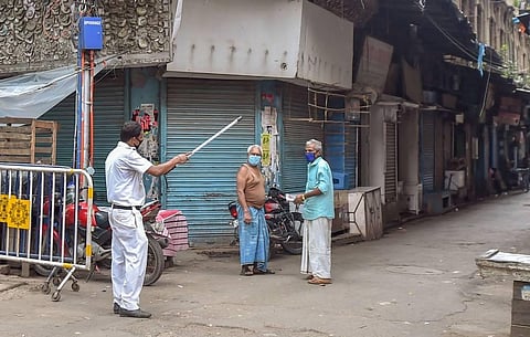 (For representation) A policeman instructs local residents to go back their houses during a complete lockdown to curb the spread of coronavirus in Kolkata. (Photo | PTI)