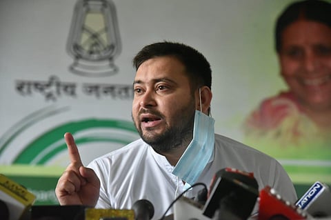 RJD leader Tejashwi Yadav addressing reporters in Patna on Saturday (Photo | EPS)
