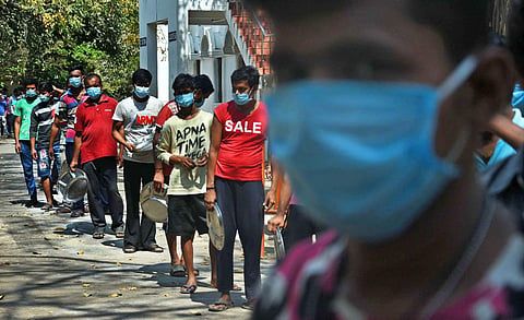 Migrant labourers stand in queue to get their lunch at a college in Chennai during the lockdown. (File Photo | Ashwin Prasath, EPS)