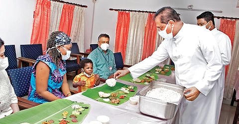 Fr Paul Karedan serving Onasadya to Jin and his mother at Lisie Hospital