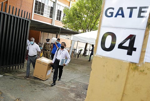 Sri Lankan polling officers carry election material as they dispatch them to polling centers ahead of the parliamentary elections in Colombo. (Photo | AP)
