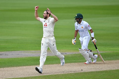England's Chris Woakes reacts during the first day of the first Test cricket match between England and Pakistan at Old Trafford in Manchester. (Photo | AFP)