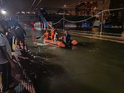 NDRF personnel rescue passengers from a local train stranded between Masjid Bunder and Byculla stations on the Central line during heavy rain in Mumbai Wednesday Aug. 5 2020. (Photo | PTI)