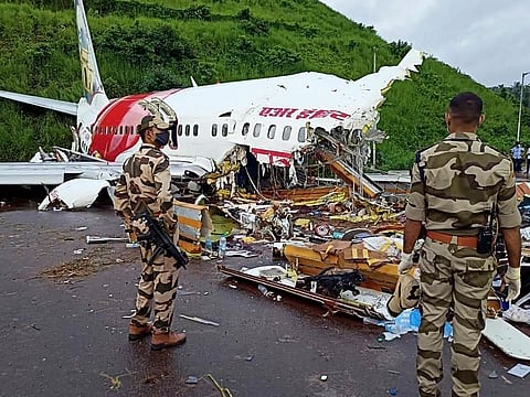 Army personnel stand guard at the site of the wreckage of Air India Express flight at Kozhikode International Airport in Karipur. (Photo| ANI)