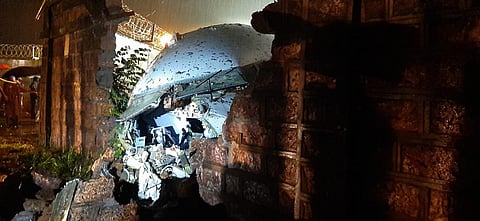 A part of the Air India Express flight is seen through a broken wall after it skidded off a runway while landing at the airport in Kozhikode, Kerala state, India, Friday, Aug. 7, 2020.  (Photo | AP)