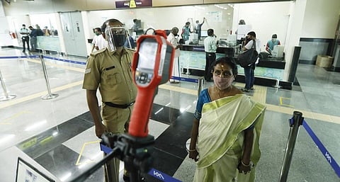 Kochi Metro reopened on Monday with the required Covid-19 protocol in place.  A commuter under going thermal scanning at a metro station. (Photo | Arun Angela, EPS)