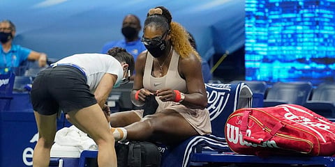 Serena Williams has her ankle taped by a trainer during a medical timeout during a semifinal match of the US Open against Victoria Azarenka. (Photo | AP)