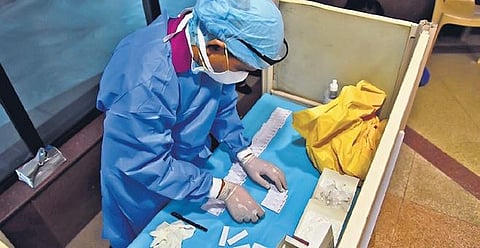 A health worker collects samples at Civic Centre in New Delhi | PARVEEN NEGI