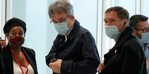 Satirical newspaper Charlie Hebdo's chief editor, Laurent Sourisseau, known as Riss (C) arrives at the courtroom for the opening of the 2015 attacks trial in Paris. (Photo | AP)