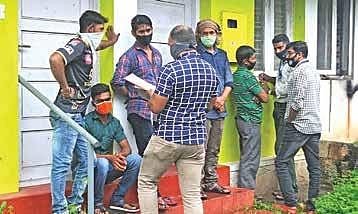 Special Branch officers recording the statement and collecting evidence from the co-habitants of su spected Al-Qaeda operatives in front of the NIA office.