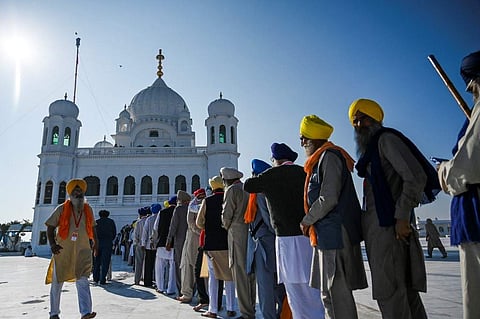 Sikh pilgrims stand in a queue to visit the Shrine of Baba Guru Nanak Dev at Gurdwara Darbar Sahib in Kartarpur, Pakistan. (File Photo | AFP)