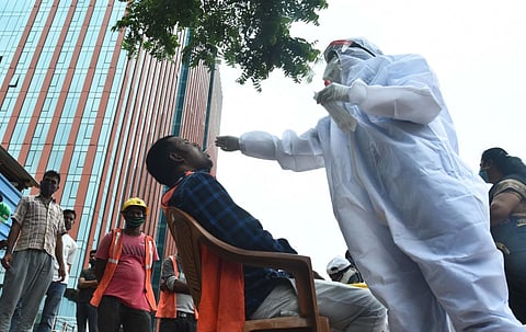 Chennai corporation collecting swabs from migrant workers who are working at a construction site at OMR (Photo | Ashwin Prasath, EPS)