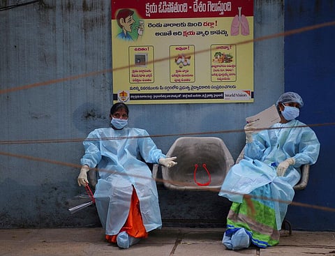 Health workers take rest while waiting to collect nasal swab samples to test for COVID-19 in Hyderabad, India, Tuesday, Sept. 22, 2020. (Photo | AP)