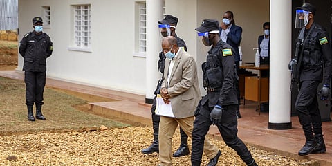 Paul Rusesabagina (C), whose story inspired the film 'Hotel Rwanda', is led out in handcuffs from the Kicukiro Primary Court in Kigali. (Photo| AP)