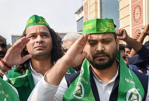 RJD leaders Tejashwi Yadav (front) and Tej Pratap wearing party caps during the open session of Rashtriya Janata Dal at Bapu Sabhagar in Patna Tuesday Dec. 10 2019. (File | PTI)