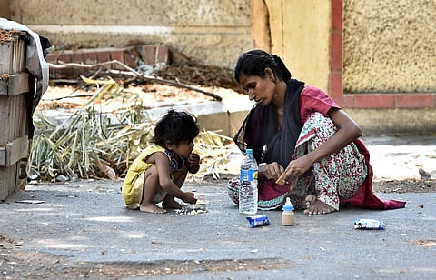 This homeless woman feeds her kid with the sourced food, without worrying least about filling her stomach. (Photo for representational purposes | P Jawahar, EPS)