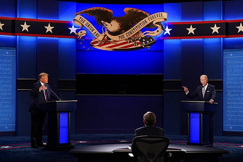 US President Donald Trump, left, and Democratic presidential candidate former Vice President Joe Biden, right, with moderator Chris Wallace, center, of Fox News. (Photo | AP)
