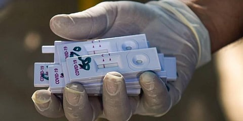 A health worker holds samples collected for COVID-19 test via rapid antigen testing. (File Photo | PTI)