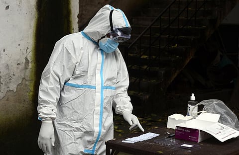 A health worker in PPE coveralls collects COVID-19 samples. (File photo| Parveen Negi, EPS)