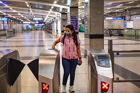 A commuter exits a station after Delhi Metro resumed services with curtailed operation of the Yellow Line and Rapid Metro amid the ongoing coronavirus pandemic in New Delhi. (Photo | PTI)