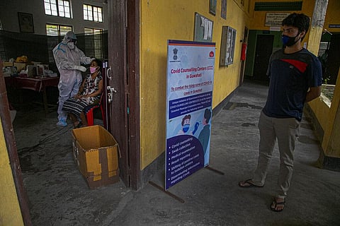 An Indian health worker takes a nasal swab sample of a woman to test for COVID-19 as a man waits for his turn in Gauhati, India, Sunday, Sept. 6, 2020.  (Photo | AP)
