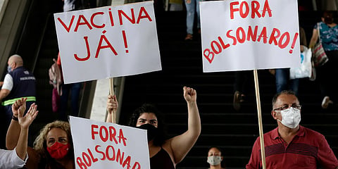 Demonstrators protest Brazilian President Jair Bolsonaro's handling of the coronavirus, at a bus station in Brazilia. (File photo| AP)