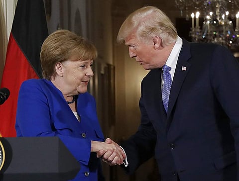 US President Donald Trump shakes hands with German Chancellor Angela Merkel. (Photo| AP)