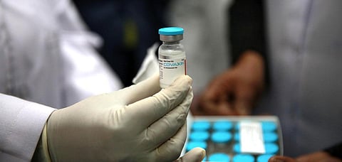 A health official shows a Covaxin vaccine dose after a consignment of the vaccine arrived at Kalawati Saran hospital in New Delhi. (Photo | Shekhar Yadav, EPS)